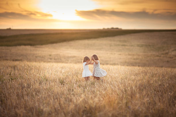 Children happiness in the field with rye